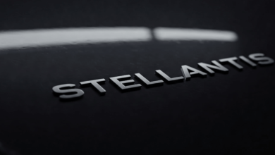 Stellantis logo on a dark vehicle surface, representing the Stellantis tariff impact on Jeep and Ram.