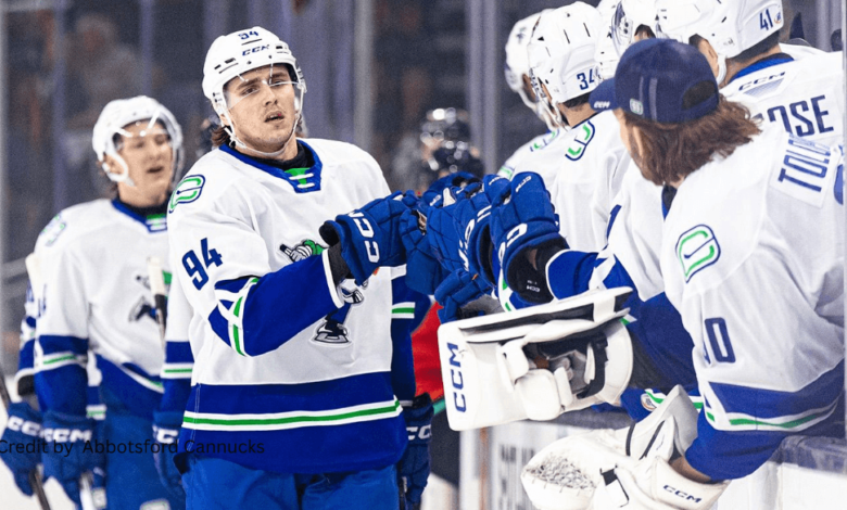 Players celebrating after the Canucks 4-1 win over Firebirds during a crucial AHL matchup
