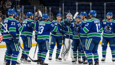 Abbotsford Canucks players cheering on the ice after winning Game 5 against Colorado Eagles