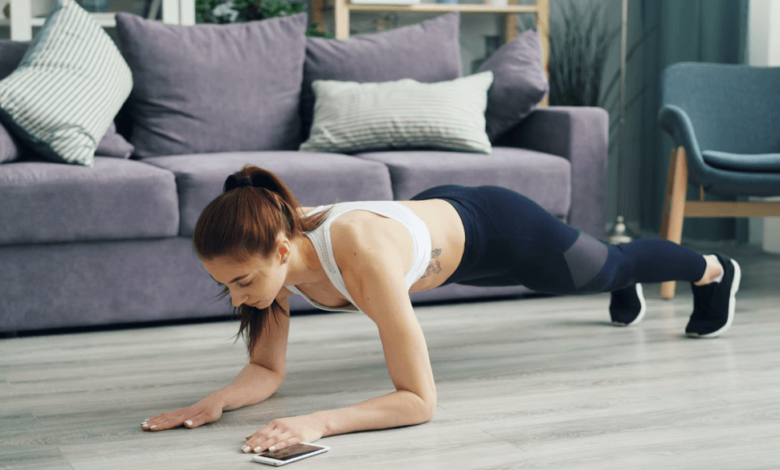Woman performing HIIT workouts at home.