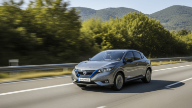 A Nissan e-Power hybrid car driving smoothly on a highway surrounded by greenery