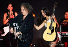 Olivia Rodrigo and Robert Smith singing together on Glastonbury’s Pyramid Stage during her 2025 headline performance