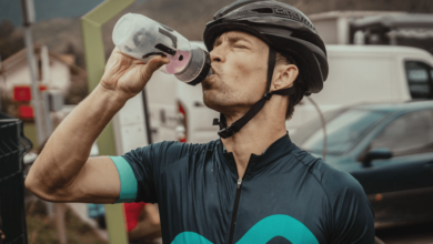Athlete rehydrating with electrolyte drink during marathon—hydration strategies for athletes