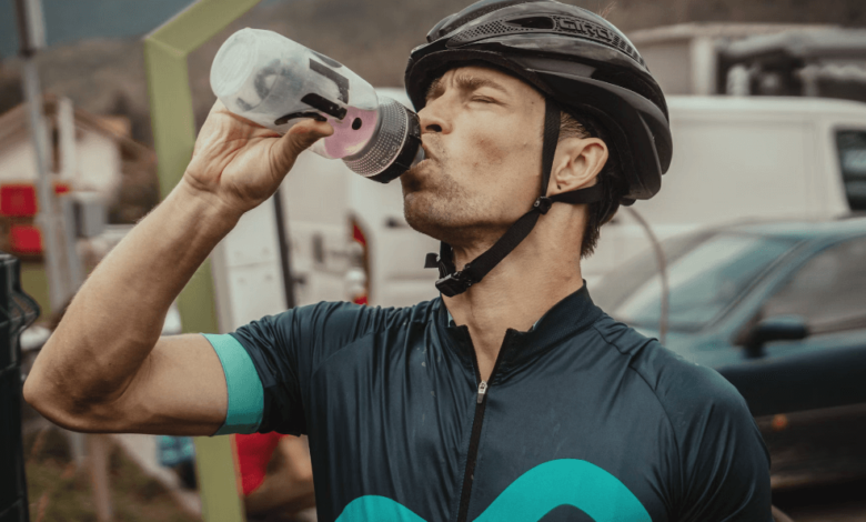 Athlete rehydrating with electrolyte drink during marathon—hydration strategies for athletes