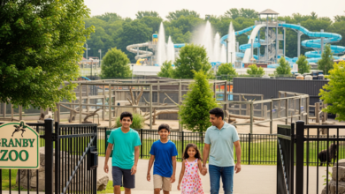 Family entering Granby Zoo with animal exhibits and water park in the background