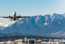 Flight taking off from Vancouver airport with mountains in the background