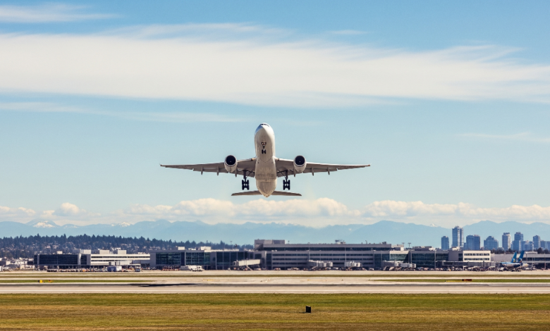 Airplane taking off from Vancouver YVR airport in summer sky, symbolizing cheap domestic flights in June 2025