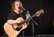 Lewis Capaldi singing live on stage, announcing his 2025 Australia tour with dates in Melbourne, Sydney, Brisbane, Adelaide, and Perth