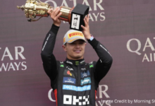 Lando Norris celebrates victory at the 2025 British Grand Prix in Silverstone with a trophy in hand