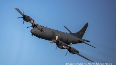 Royal Canadian Air Force CP-140 Aurora flying low over Burrard Dry Dock Pier in North Vancouver