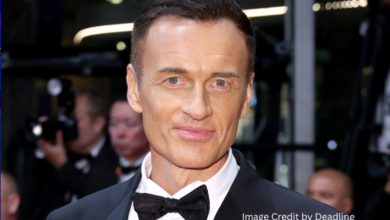 Julian McMahon smiling at a film premiere event before his passing in 2025
