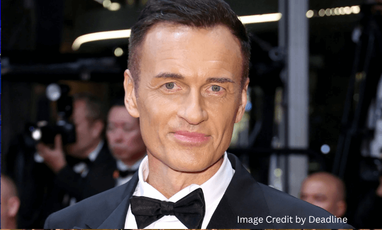 Julian McMahon smiling at a film premiere event before his passing in 2025