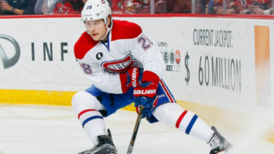 Montreal Canadiens defenseman Nathan Beaulieu in action during an NHL game on the ice, showcasing his hockey skills.