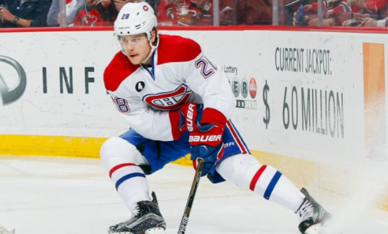 Montreal Canadiens defenseman Nathan Beaulieu in action during an NHL game on the ice, showcasing his hockey skills.