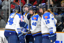 PWHL Vancouver players celebrate during a high-intensity match in front of a packed crowd