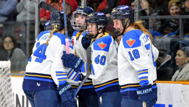 PWHL Vancouver players celebrate during a high-intensity match in front of a packed crowd