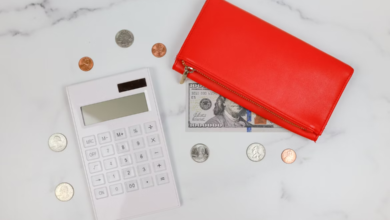 Budget smarter with a calculator, coins, and a wallet on a marble surface