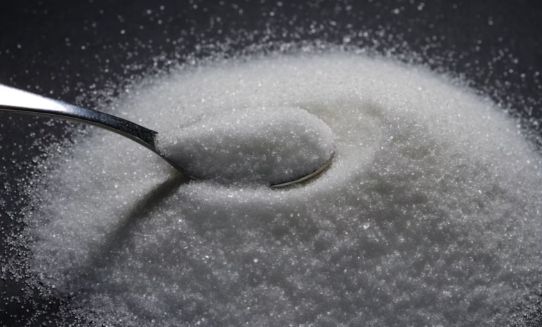 Granulated sugar with spoon – visual contrast for popular sugar substitute stroke risk debate
