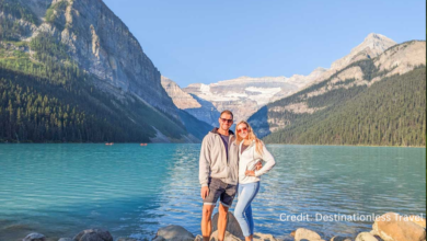 Couple overlooking Lake Louise on a budget-friendly Canadian road trip