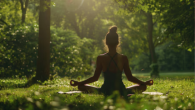 Young woman meditating in a green London park as part of budget wellness routine in the UK