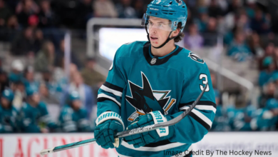 Henry Thrun skating in an NHL game, now part of the Toronto Maple Leafs after being traded for Ryan Reaves