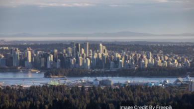 Aerial view of Vancouver’s high-rise residential towers between mountains and the Pacific Ocean