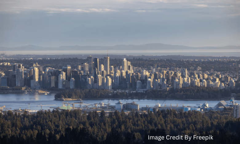 Aerial view of Vancouver’s high-rise residential towers between mountains and the Pacific Ocean