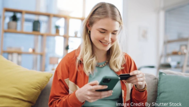 Woman using a Canadian mobile banking app to track spending and save money on her smartphone in 2025
