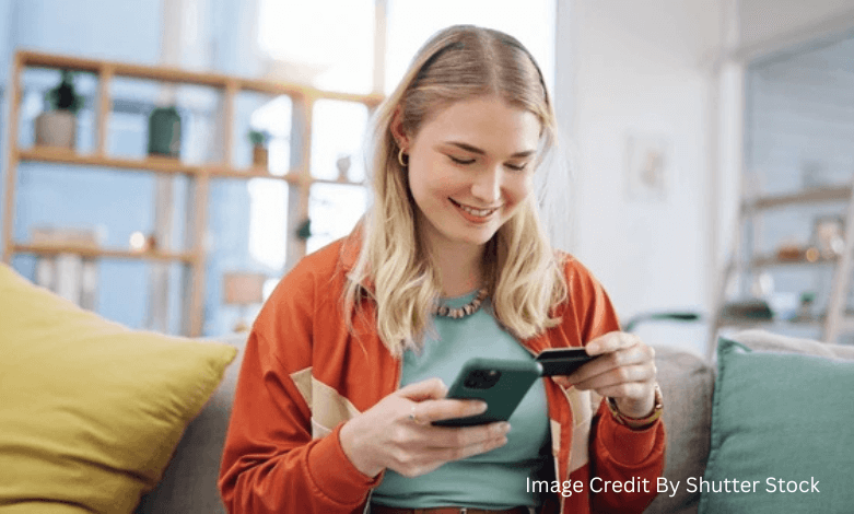 Woman using a Canadian mobile banking app to track spending and save money on her smartphone in 2025