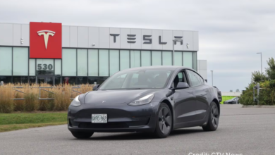 Tesla Model 3 in a showroom with financial charts displaying quarterly revenue drop