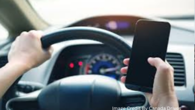 A driver using a dashboard-mounted phone, following Canada’s 2025 handheld device ban