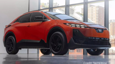 Sleek 2026 Subaru Uncharted EV electric crossover parked in an urban landscape with modern architecture