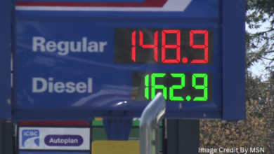 Digital gas station price board in British Columbia showing current pump prices for regular and premium fuel