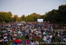 People watching a free outdoor movie at Stanley Park on a summer night in Vancouver