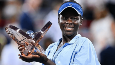 Victoria Mboko wins Canadian Open, proudly holding her trophy and smiling.