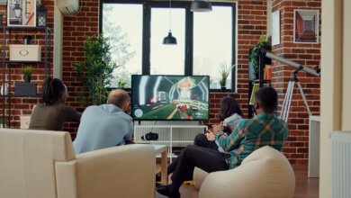 People enjoying entertainment together while watching TV at home