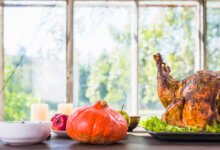 Roasted Thanksgiving turkey with pumpkin and apples on a table