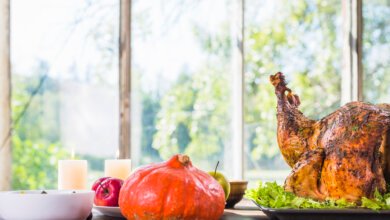 Roasted Thanksgiving turkey with pumpkin and apples on a table