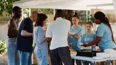Volunteers distributing food at a community charity event.