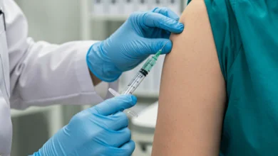 A healthcare professional administering a measles revaccination shot to a patient to ensure immunity.