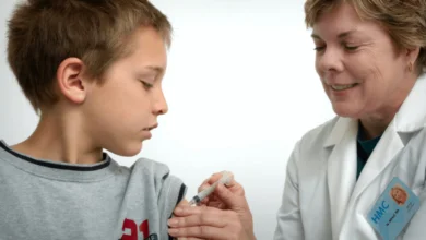 Healthcare professional responding to measles outbreak by administering MMR vaccine to a child in Alberta.