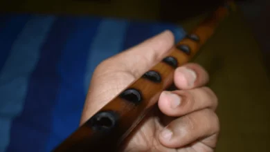 Jessica Sparvier-Wells performing 'Prairie Dusk' with her flute, embodying Indigenous resilience and prairie landscapes