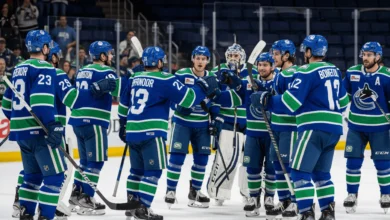 Abbotsford Canucks players cheering on the ice after winning Game 5 against Colorado Eagles