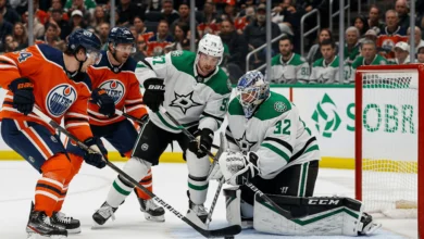 Edmonton Oilers and Dallas Stars players battling on the ice during an NHL game