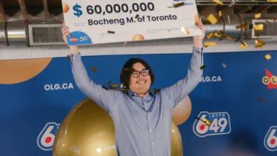 Toronto man wins $60M Lotto Max jackpot, holding a winner’s cheque, celebrating at lottery event.