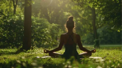 Young woman meditating in a green London park as part of budget wellness routine in the UK