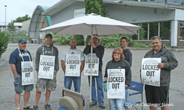 IBEW Local 213 FortisBC workers holding strike signs outside facility during contract dispute
