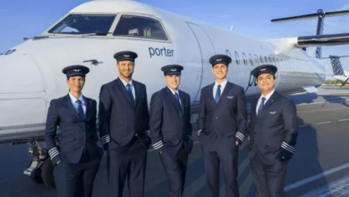 Porter Airlines pilots stand in front of their aircraft after joining the ALPA Union, showcasing a historic moment in Canadian aviation.