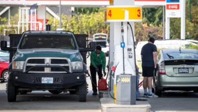 Line of cars at a Metro Vancouver gas station with gas price board showing $1.91 per litre