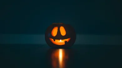 spooky October events glowing jack-o'-lantern pumpkin with a candle inside, symbolizing the spirit of Halloween and fright festivals.